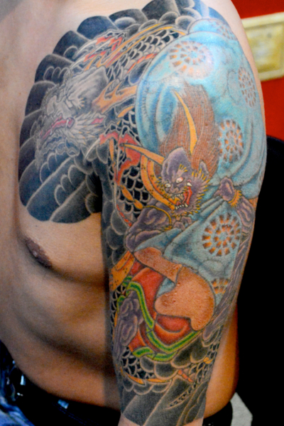 和彫り腕胸に「龍と風神」の刺青