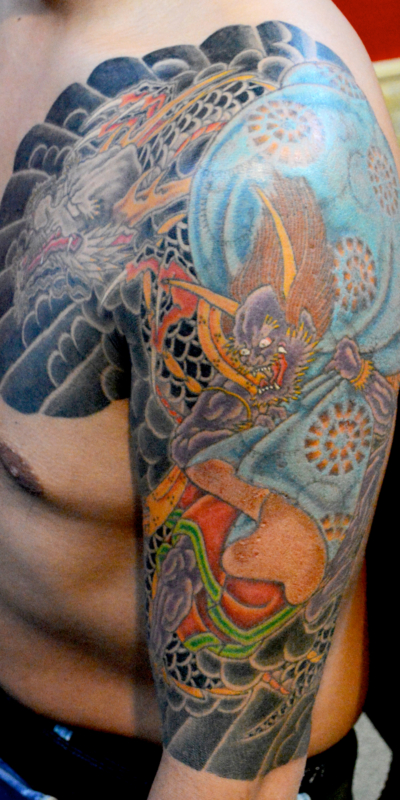 和彫り腕胸に「龍と風神」の刺青