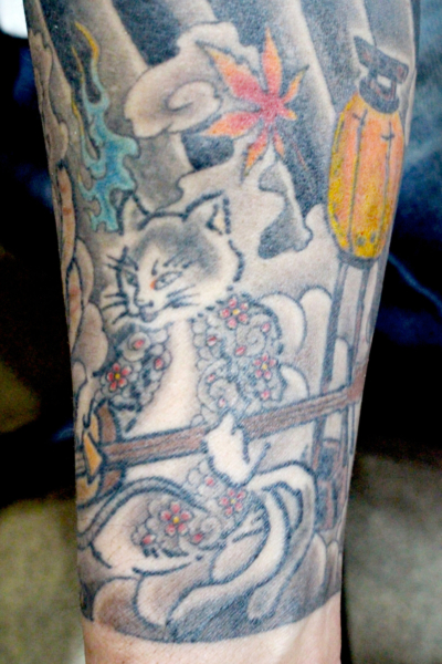 和彫り腕に「三味線を弾く猫」の刺青