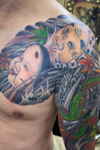 和彫り腕胸に「ひょっとこおかめと般若天狗と狐」の刺青