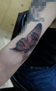 B&G 腕に「蝶に顔」のタトゥー