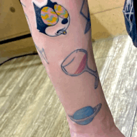 腕に「フィリックス・ザ・キャット」のワンポイントタトゥー